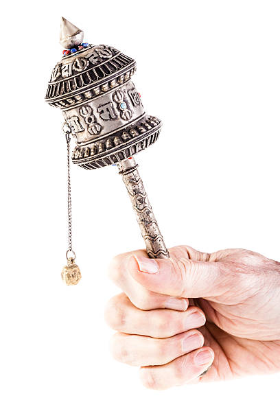 Holding a Prayer wheel Tibetan Prayer wheel or Mani wheel isolated over a white background buddhist prayer wheel stock pictures, royalty-free photos & images