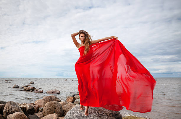 istock nude woman with red fabric 489763518