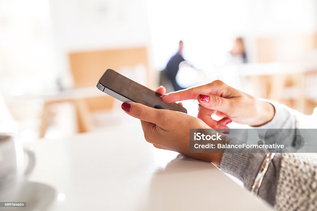 Female smart phone Female using app on smart phone.Sitting in the cafe. 2015 Stock Photo