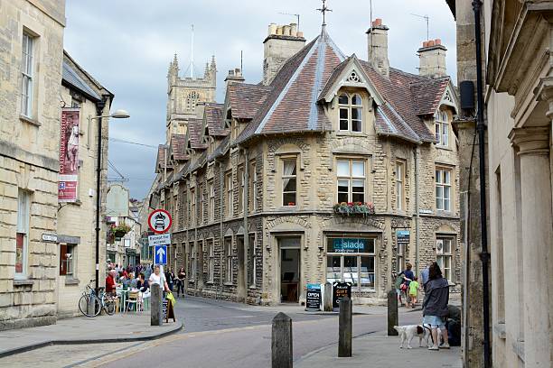 Cirencester Town Cirencester, England - August 3, 2015 : A street scene of Cirencester town centre, members of the public can be seen walking around chesterton photos stock pictures, royalty-free photos & images