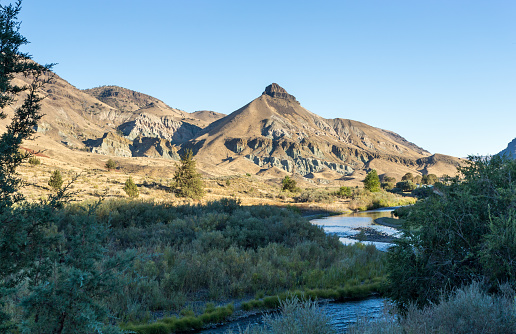 Sheep Rock and John Day river in John Day Fossil Beds National Monument at sunset. Central Oregon