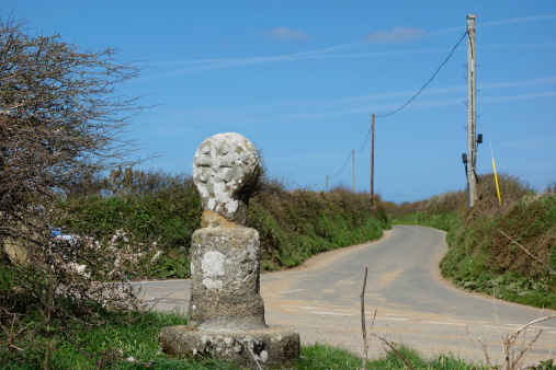 Old Stone Road Sign Marker on the country road in Cornwall England