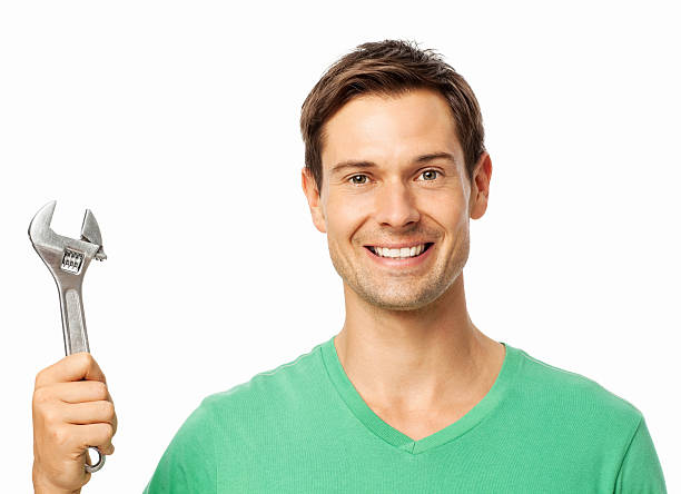 istock Confident Repairman Holding Adjustable Wrench 489773479