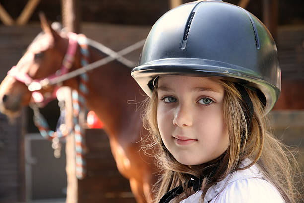 istock Little girl and brown Horse 489775005
