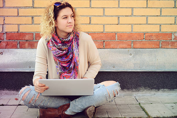 istock beautiful young woman with a laptop 489775660