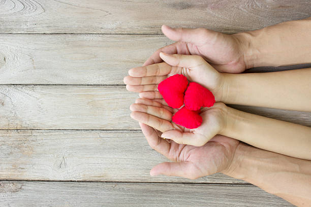 istock help,Heart in Hand on wood 489776494