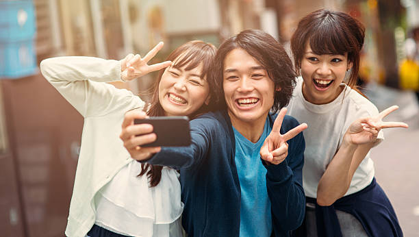 istock Happy japanese friends taking a selfie 489776546