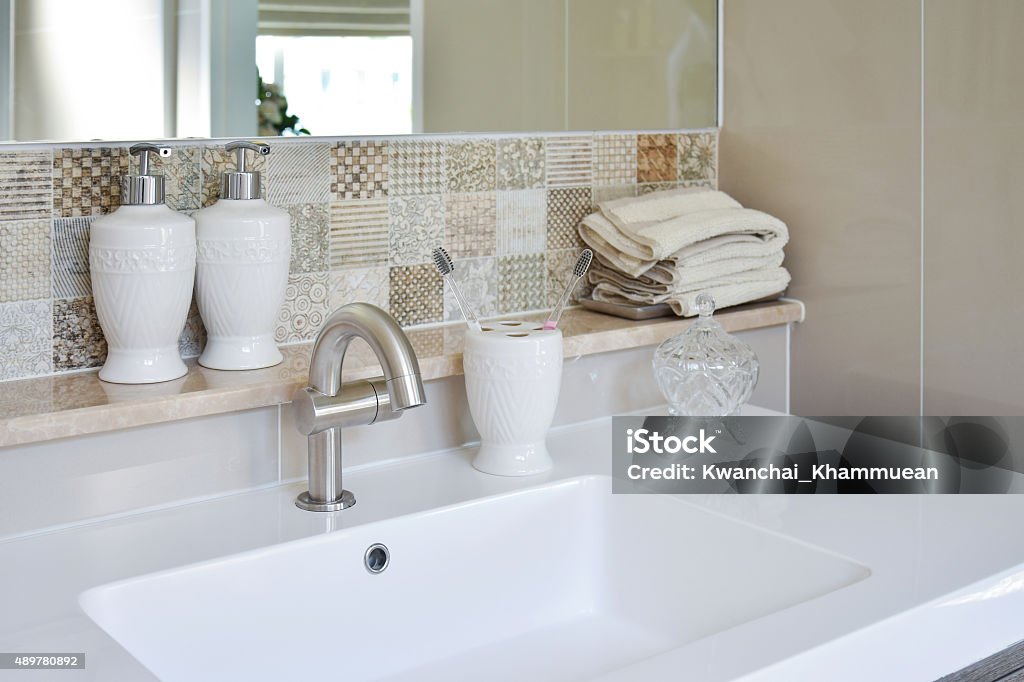 washbasin with faucet and liquid soap bottle at home 2015 Stock Photo