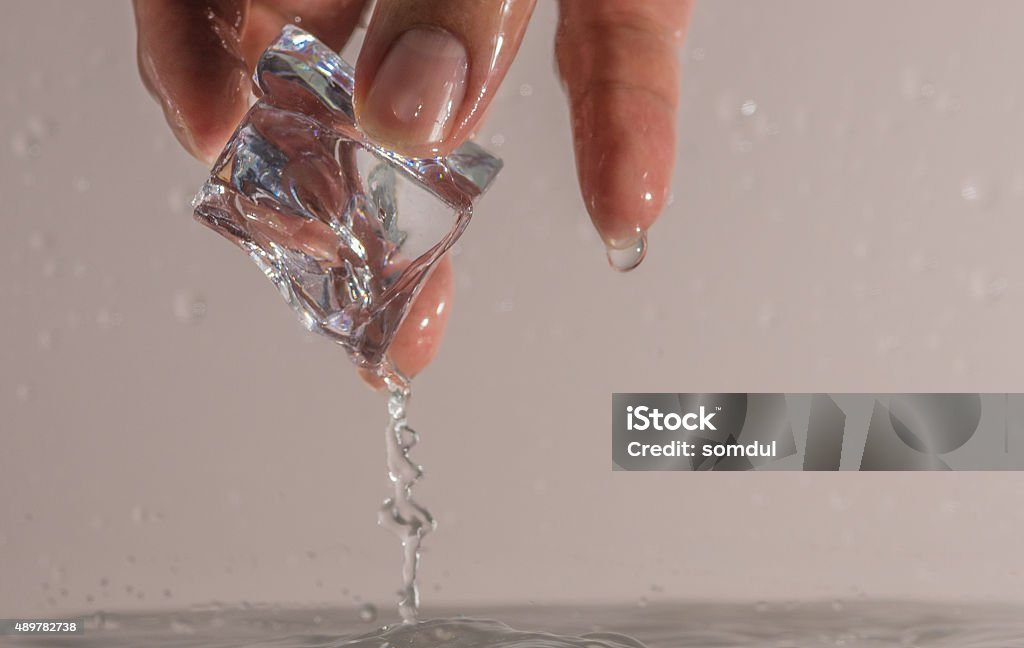 Picking ice cube Picking ice cube from water 2015 Stock Photo