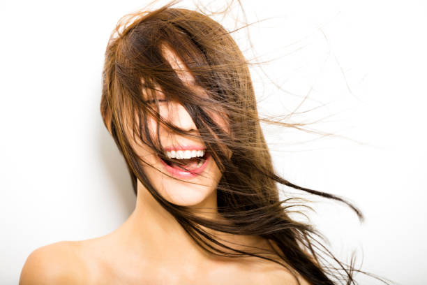istock young Woman  with hair motion on white background 489783096