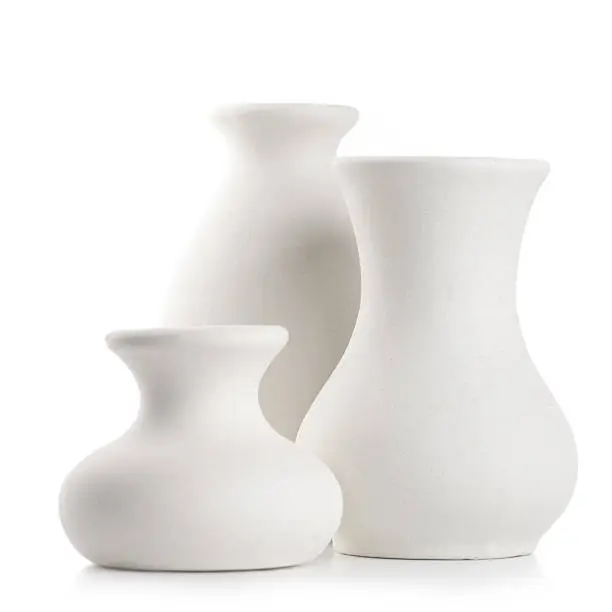 Three empty white unglazed ceramic vases isolated on white background.
