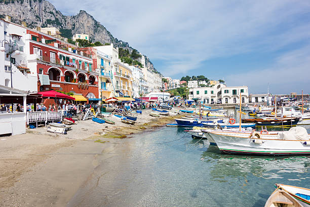 Capri, Italy - June 7, 2014: Capri Island Landscape, Marina Grande, some people walking on the seaside in the background.