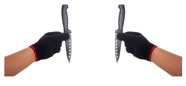 istock Hand with black glove holding knife 489801740
