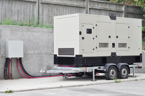 Big Backup Generator for Office Building Сonnected to the Control Panel with Cable Wire