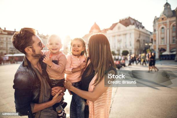 Young Smiling Family Spending A Day In The City Stock Photo - Download Image Now - 2015, Adult, Bonding