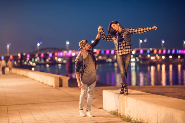istock Happy couple having fun on a riverside at night. 489804320