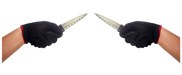 istock Hand with black glove holding knife 489804418