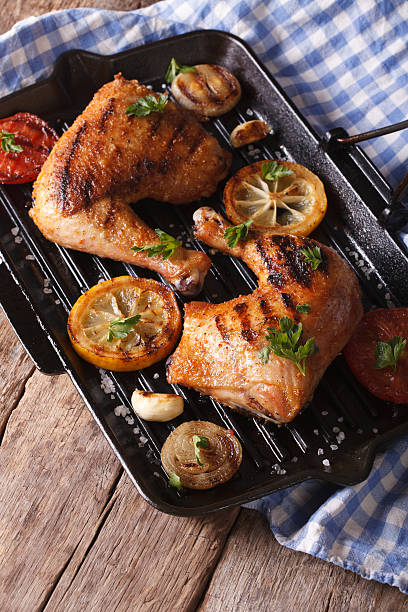istock Chicken thighs and vegetables on grill pan vertical top view 489805070