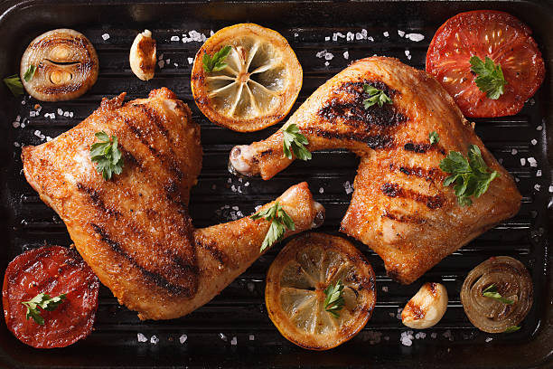 istock chicken legs and vegetables on grill pan closeup. Top view 489805882
