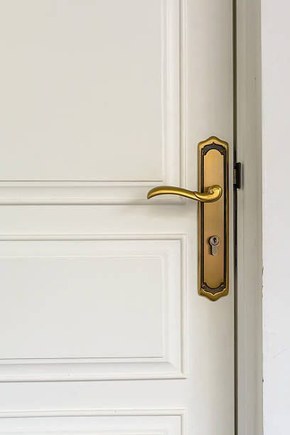 istock classic golden door handle on white door 489806162
