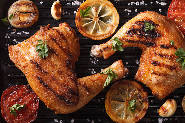 istock chicken legs and vegetables on grill macro. Top view horizontal 489806246