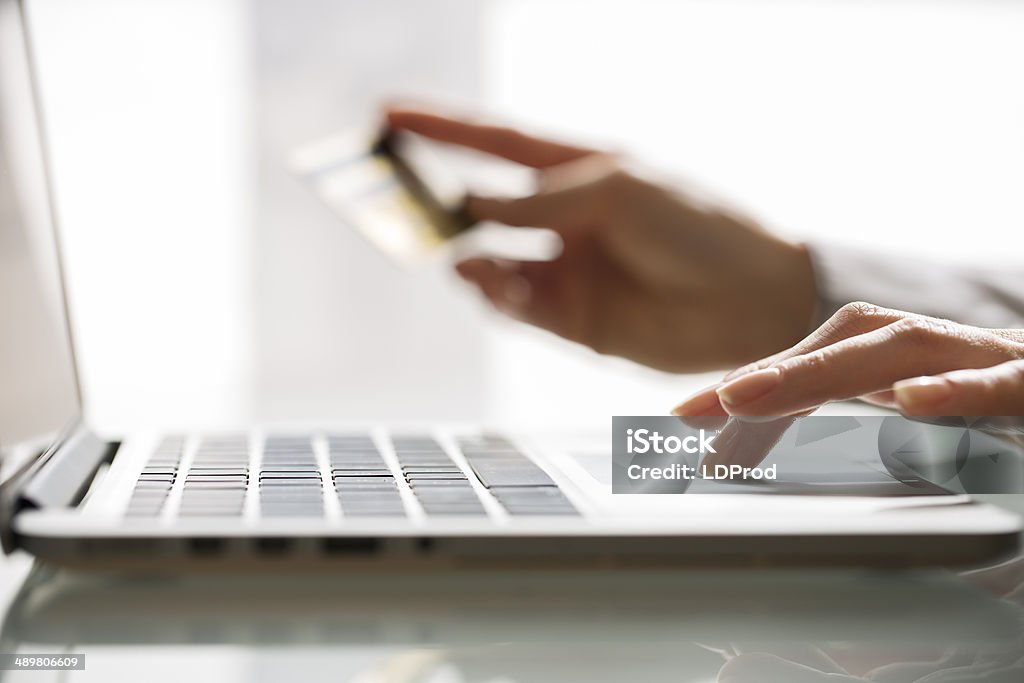 Woman shopping using laptop and credit card .indoor.close-up Female computer keyboard online buy order internet Adult Stock Photo