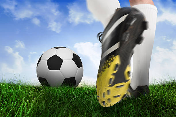 istock Football boot kicking ball 489806969