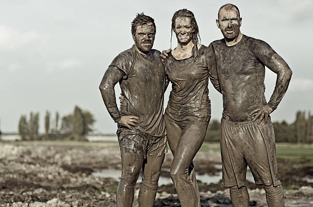 istock Team posing for a group pic in the mud 489807226