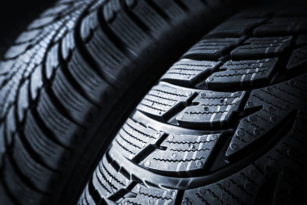 istock Car tires on black background 489808112