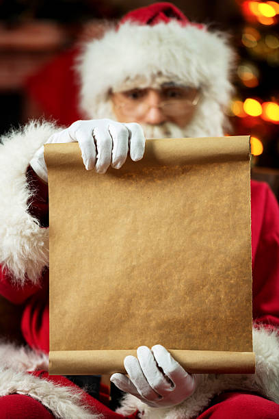 istock Santa Claus sitting at home and reading a list. 489808428