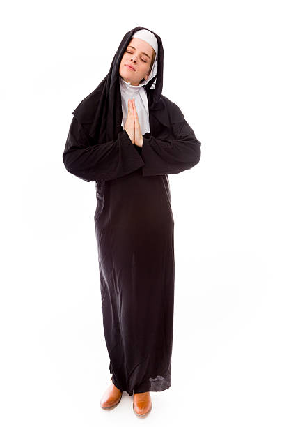 istock Young nun in prayer position 489808443