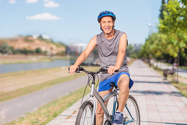 istock Cheerful senior biker posing on a sidewalk 489808724