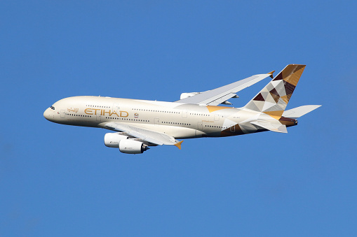 Etihad Airways Airbus A380-861, approaching to land at Heathrow in London, flies low over the trees.
