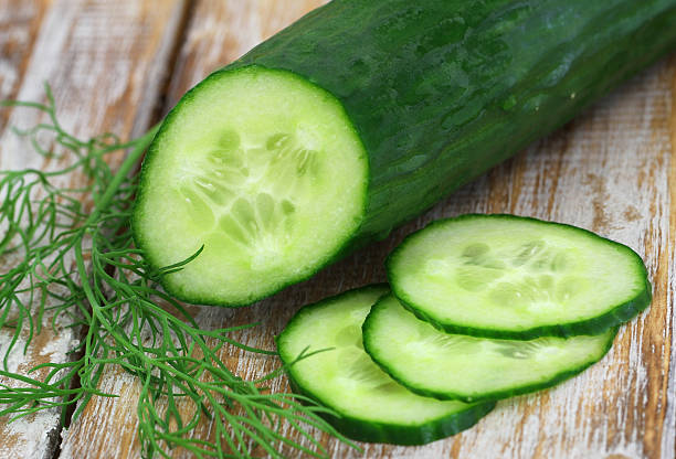 istock Cucumber and fresh dill on rustic wooden surface, closeup 489809154