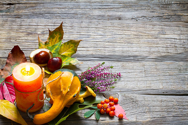 istock Autumn still life with candle on old boards 489809774
