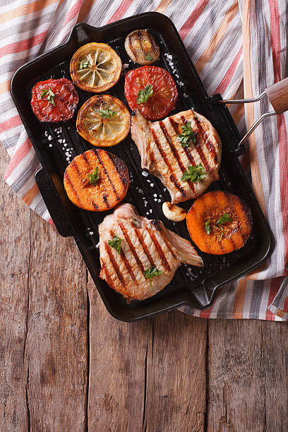 istock Grilled pork and pumpkin on grill pan. Vertical top view 489809968