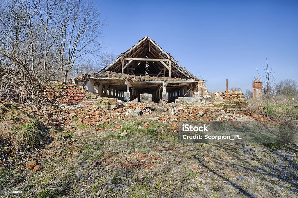 Old, abandoned and forgotten barn Partially collapsed old red brick barn Abandoned Stock Photo