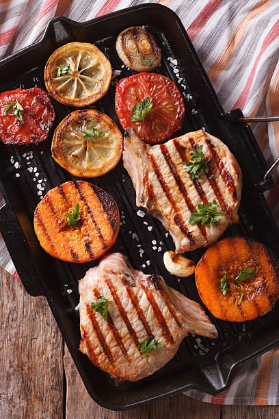 istock Grilled pork and pumpkin on grill pan. Vertical top view 489810208