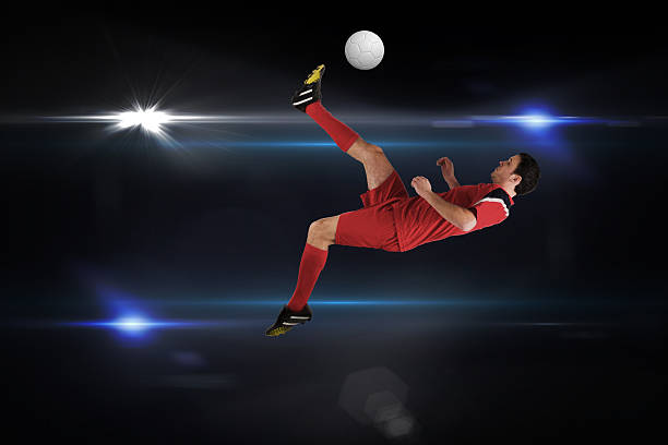 istock Football player in red kicking 489811485