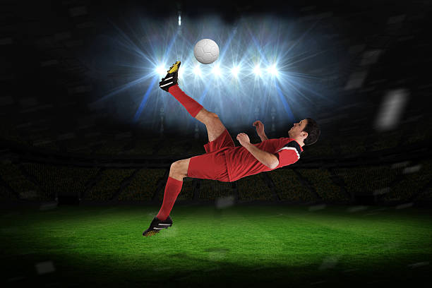 istock Football player in red kicking 489811493