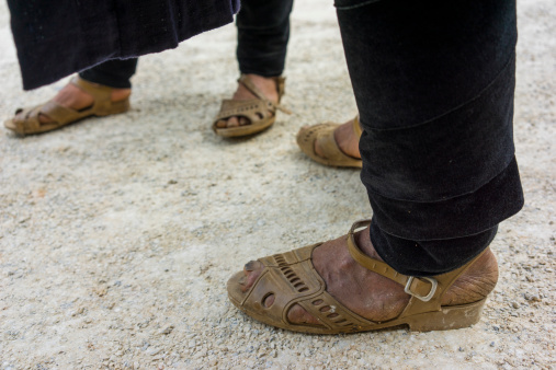 Sandal on Human Foot over Tiled Floor at Medina District in Marrakesh, Morocco