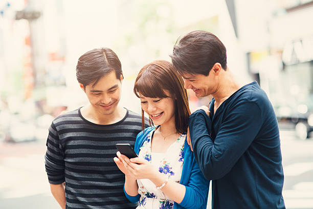 istock Happy japanese friends surfing the net 489813016