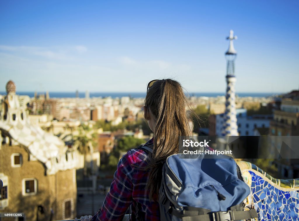 Woman tourist Rear view of young female tourist looking at view in Parc Guell in Barcelona, Spain. Barcelona - Spain Stock Photo