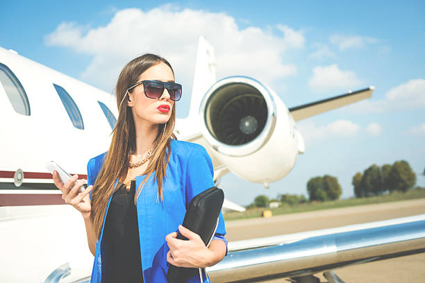 istock Young businesswoman next to private jet 489816022