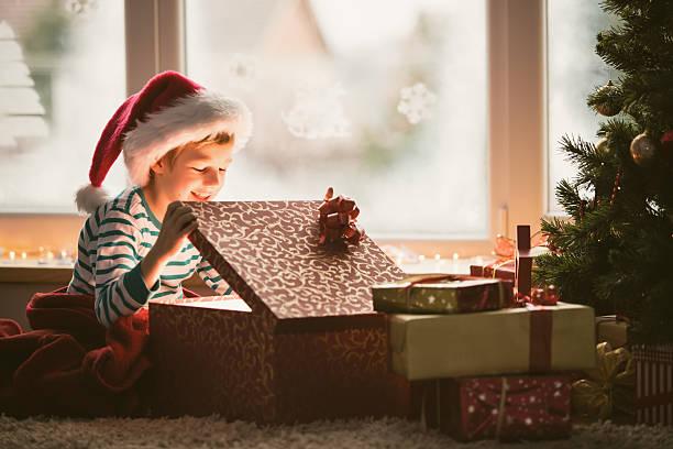 istock Little boy opening Christmas present 489831580