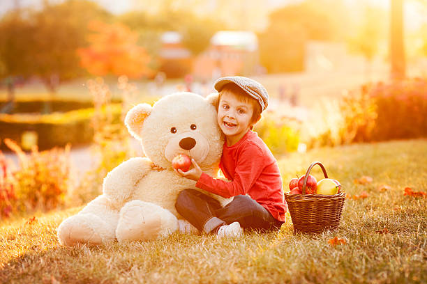 istock Adorable little boy with teddy bear friend in park 489834406