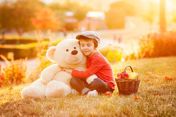 istock Adorable little boy with teddy bear friend in park 489834458