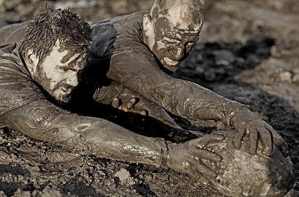 istock Two men fighting for rugby ball in mud 489834748