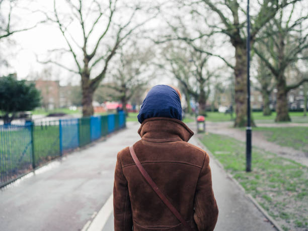 istock Woman walking in a park 489835624