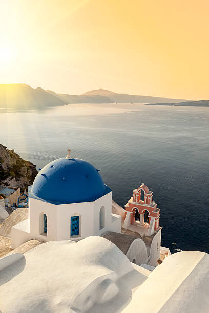 Reflecting sun on a blue dome in Oia stock photo